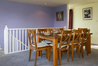 a dining room with a wooden table and chairs at 4 Bell Lodge, Thorpeness in Thorpeness