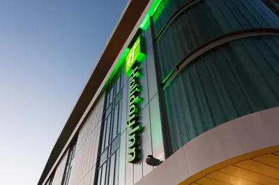 a green sign on the side of a building at Holiday Inn Southend by IHG in Southend-on-Sea