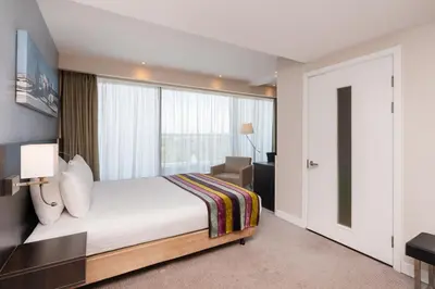 a bedroom with a bed and a large window at Holiday Inn Southend by IHG in Southend-on-Sea
