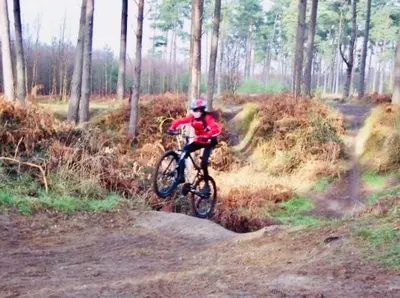 a person riding a bike on a dirt trail at Kingfisher Nook at Waveney Farm in Hoxne