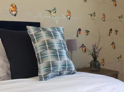 a pillow sitting on a bed in a bedroom at Kingfisher Nook at Waveney Farm in Hoxne