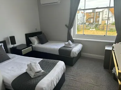 a hotel room with two beds and a window at The Royal Hotel - Clacton On Sea in Clacton-on-Sea