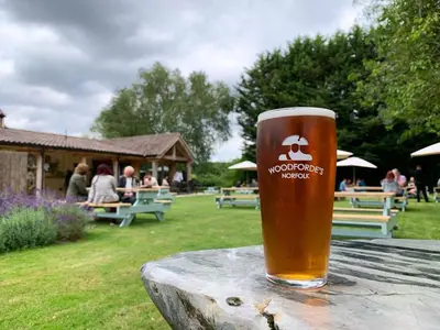 a glass of beer sitting on top of a table at Bedingfeld Arms in Swaffham