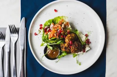 a plate of food with a salad on a table at The Bull Inn in Woolpit