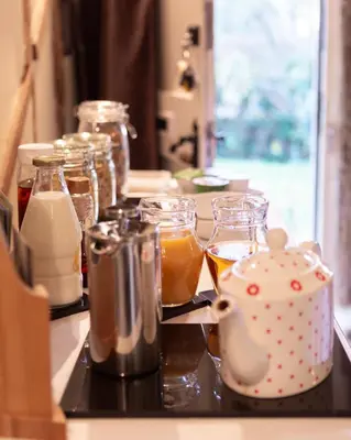 a counter with jars of food and drinks on it at Frogs Hall B&B in Eye