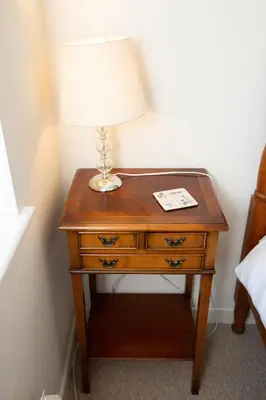 a table with a lamp on top of it at PERFECT BUSINESS ACCOMMODATION at SIDINGS FARM - Luxury Cottage Accommodation - Fully equipped & Self Catering in Pidley