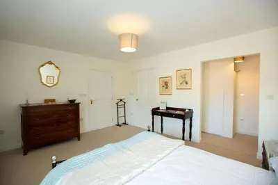a bedroom with a bed and a dresser and a piano at PERFECT BUSINESS ACCOMMODATION at SIDINGS FARM - Luxury Cottage Accommodation - Fully equipped & Self Catering in Pidley