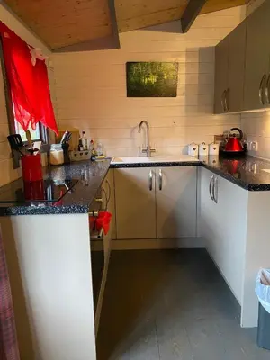 a kitchen with white cabinets and black counter tops at Thompson Hall Retreat in Thompson
