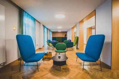 a waiting room with chairs and a table at Newnham College - University of Cambridge in Cambridge