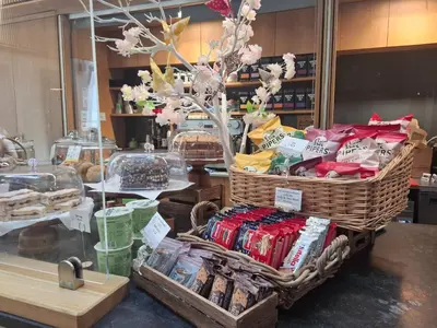 a store with baskets of food on a counter at Newnham College - University of Cambridge in Cambridge