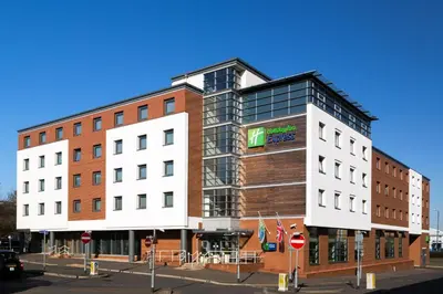 a large building on a city street with a street at Holiday Inn Express Harlow by IHG in Harlow