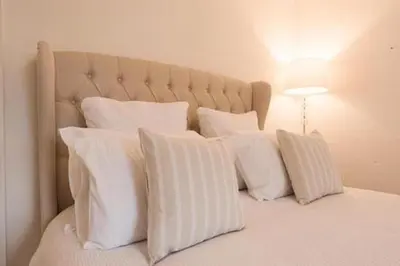 a white bed with white pillows on it at The Blackwater Suite in West Mersea