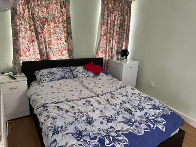 a bedroom with a bed with a blue and white comforter at Seaside resort in Felixstowe
