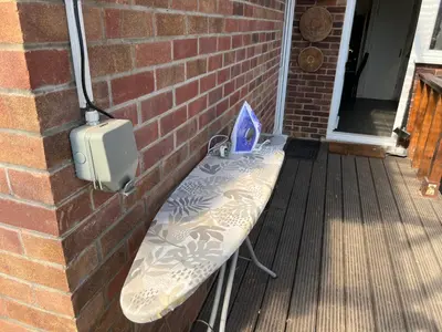 a bench on a porch next to a brick wall at Seaside resort in Felixstowe