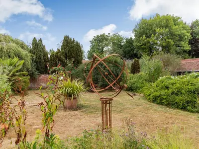 a metal sculpture in the middle of a garden at The Nest Box in Diss