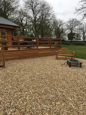 a couple of benches sitting in front of a building at The Orchard Bramble Lodge in Hadleigh