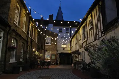a string of lights hanging over an alley with buildings at The Blue Boar - Maldon in Maldon