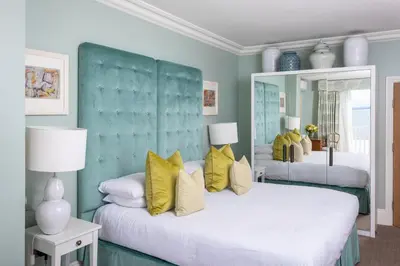 a bedroom with two beds with yellow pillows at Roslin Beach Hotel in Southend-on-Sea