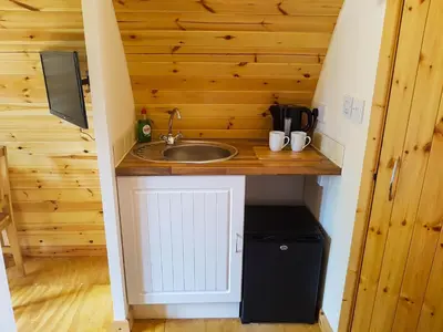 a small kitchen with a sink in a tiny house at Colemans Cottage Fishery in Wickham Bishops