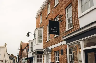 a brick building with a sign for the court house at The Coach House in Potton