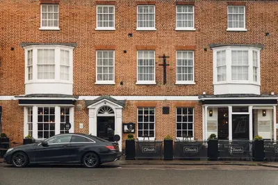 a car parked in front of a brick building at The Coach House in Potton