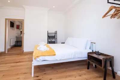 a bedroom with a white bed and a wooden floor at Birch - Three Tuns Apartments - Pettistree, Wickham Market - by Aldeburgh Coastal Cottages in Pettistree