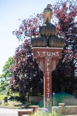 a sign with a bird sitting on top of it at Elm - Three Tuns Apartments, Pettistree, Wickham Market - by Aldeburgh Coastal Cottages in Pettistree