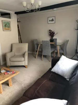 a living room with a couch and a table at A quaint Wymondham cottage in Norwich