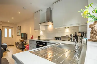a kitchen with a sink and a counter top at Delightful CENTRAL Duplex - 2 Mins To Station in Cambridge