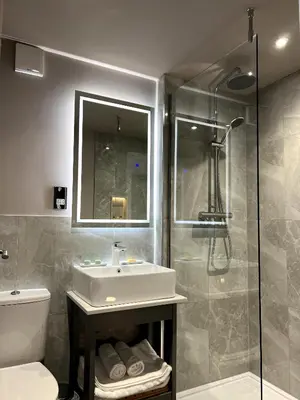 a bathroom with a sink and a shower at The Three Pickerels in Mepal