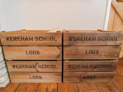 a stack of wooden boxes sitting on the floor at The Old School in Wereham