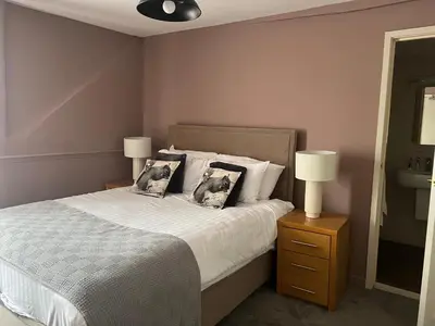 a bedroom with a bed with two pillows on it at The Bell Inn, Rickinghall in Rickinghall
