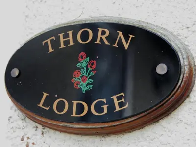 a sign for the iron lodge on a wall at Thorn House in Fen Drayton