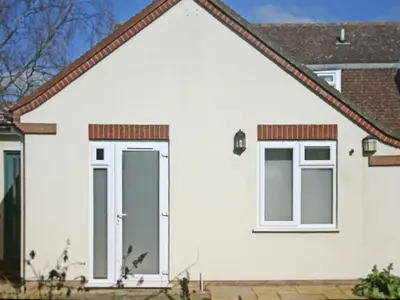 a white house with two windows at Thorn House in Fen Drayton