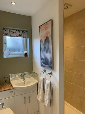 a bathroom with a sink and a mirror at Thorn House in Fen Drayton