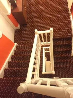 a stairwell with a white ladder in a building at Welbeck Hotel - Close to Beach, Train Station & Southend Airport in Southend-on-Sea