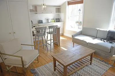 a living room with a couch and chairs and a table at Cathedral View Apartment, Flat 3 in Bury Saint Edmunds