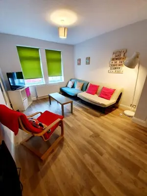 a living room with a couch and a chair at Beautiful 3 Bedroom House at the Sea Front - Amazing Location in Southend-on-Sea