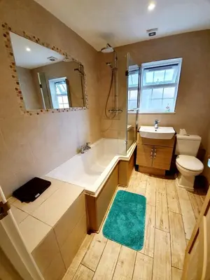 a bathroom with a tub and a toilet and a sink at Beautiful 3 Bedroom House at the Sea Front - Amazing Location in Southend-on-Sea