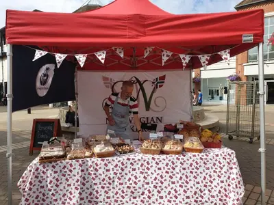 a table with a red tent with food on it at Cosy Cottage Fireplace Patio Pet Train Stn in Wivenhoe