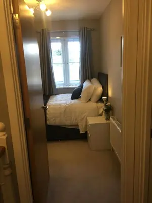 a small bedroom with a bed and a window at Villa Belle Three bedrooms Basildon in Basildon