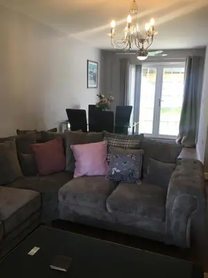 a living room with a couch with pillows on it at Villa Belle Three bedrooms Basildon in Basildon