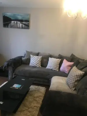 a living room with a couch and a table at Villa Belle Three bedrooms Basildon in Basildon