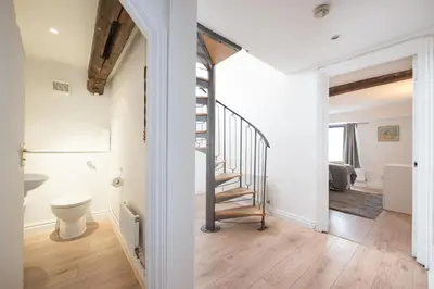 a hallway with a staircase in a house at Colchester Town Duplex Apartment in Colchester