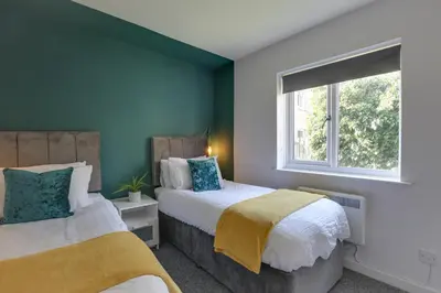 a bedroom with two beds and a window at George Suite - Central Location - Free Allocated Parking in Chelmsford