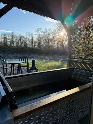 a view from the back of a patio with a table at The Stables & Silos in Braintree