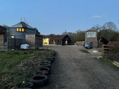 a group of tires lined up on the side of a road at The Stables & Silos in Braintree