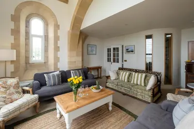 a living room with couches and a coffee table at The Tower in Thorpeness