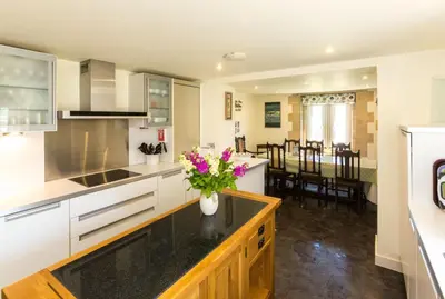 a kitchen with a vase of flowers on a counter at The Tower in Thorpeness