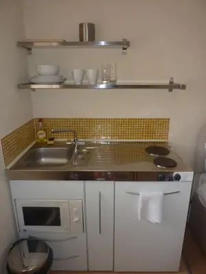 a small kitchen with a sink and a microwave at WynnStay Studio Apartments in Southend-on-Sea